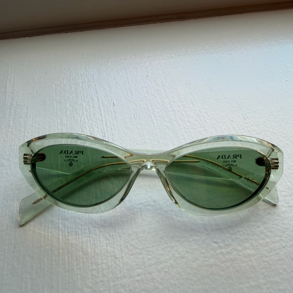 Prada Clear Frame Sunglasses with Green Lenses